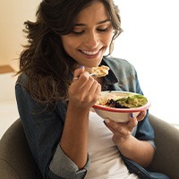 Woman eating with our clear aligners