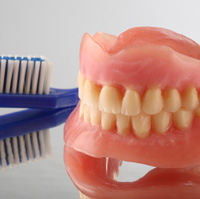 Full dentures and a blue toothbrush