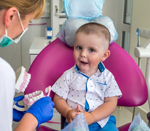 Little boy on dental chair with female dentist