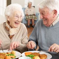 Older man and woman eating together