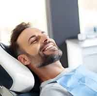 Man feeling drowsy and relaxed in the dentist’s chair