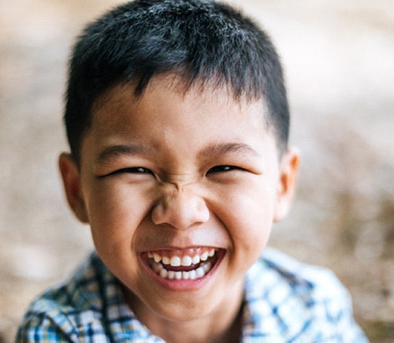 Little boy with tooth-colored filling smiling