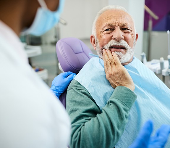 Older man with tooth pain at the dentist’s office