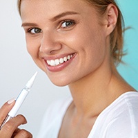Woman using whitening pen